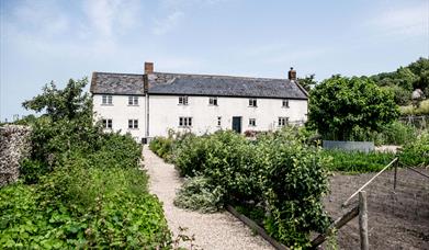 The River Cottage iconic house, with the kitchen garden visible in the foreground.