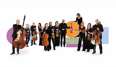 The BSO Strings Ensemble are stood with their instruments in front of a background of graphic shapes