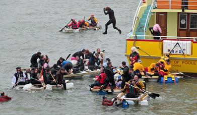 People jumping in the water in Poole