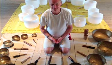 Dean Carter of centreforpuresound.org and his display of crystal singing bowls