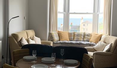 Living dining area with window seat and sea view