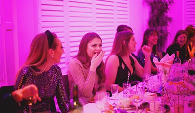 A groups of work colleagues laughing and enjoying a Christmas Party night at the Marsham Court Hotel