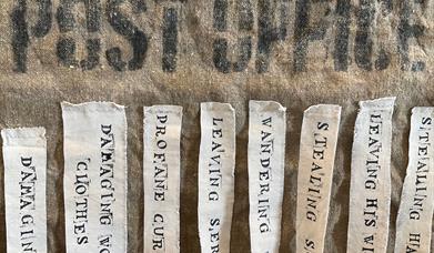 Vintage hessian mailbag with fabric labels attached