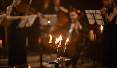 The Piccadilly Sinfonietta performing in a candlelit church.