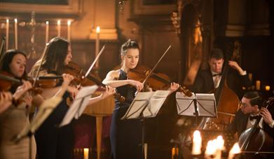 The Piccadilly Sinfonietta performing in a candlelit church