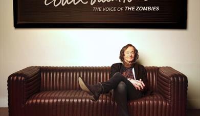 Colin Blunstone sitting on a sofa with his tour dates below.