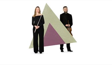 Two musicians are stood holding their instruments, either side of of a large green and purple triangle graphic.