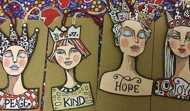 Pen and ink illustrated women with crowns, gift tags with Peace, Kind, Hope, Joy.