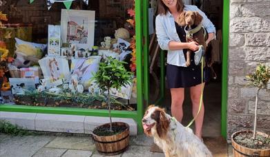 Lucy's Farm shop front with Lucy and her dogs