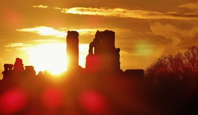 Corfe Castle with the sun shining through the ruins