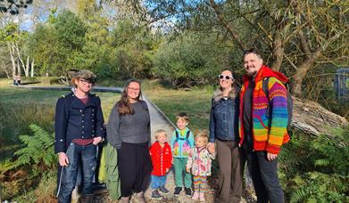 Families arriving at the Brownsea Island Community Open Day, standing on the boardwalk entrance to the nature reserve.