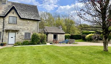 The front of Alma Cottage with large gardens to the front.